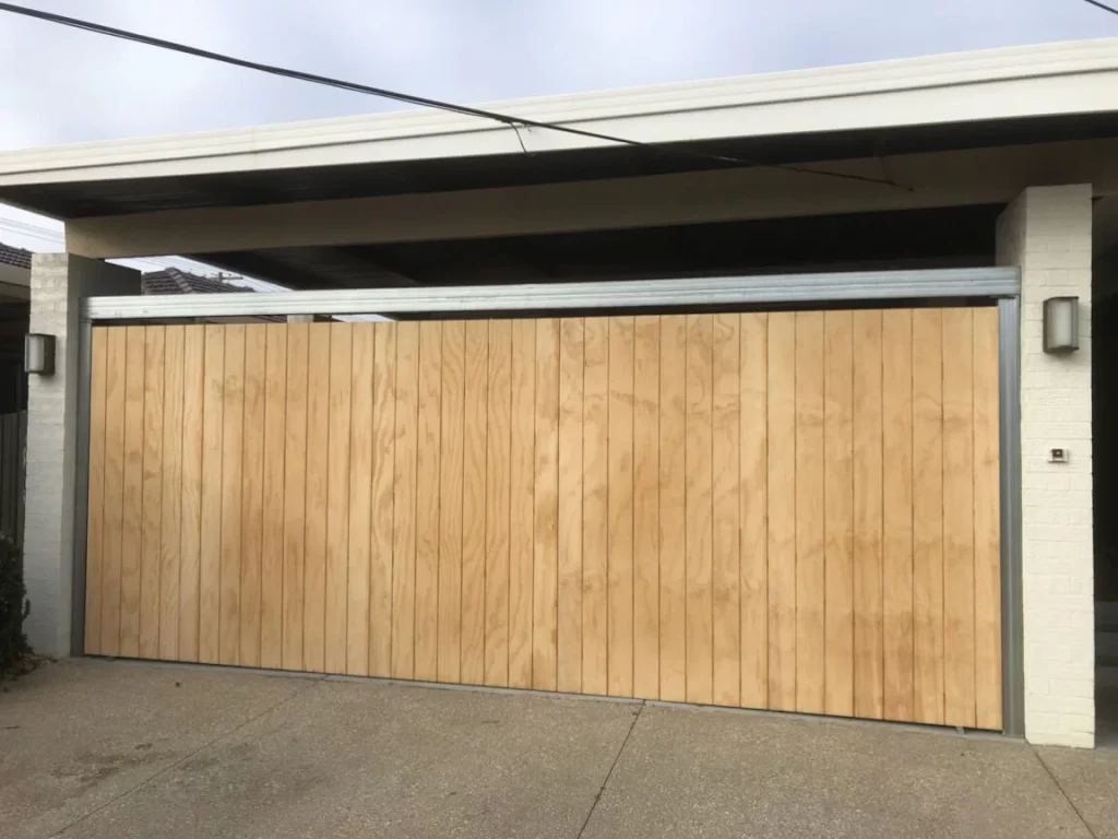 "Wooden tilt-up garage door with a modern design.
